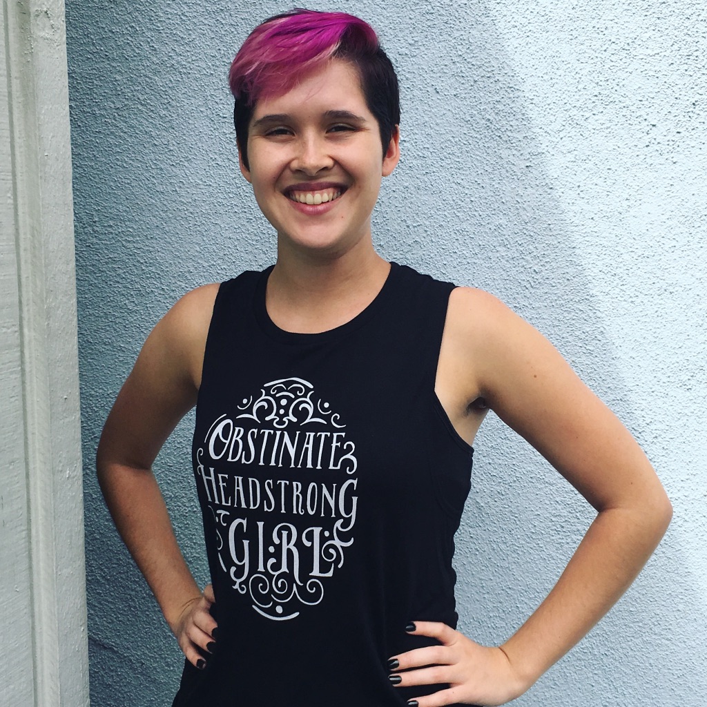 Photograph of a young woman wearing a black tank top with the "Obstinate, Headstrong Girl" design from BumbleBess.com