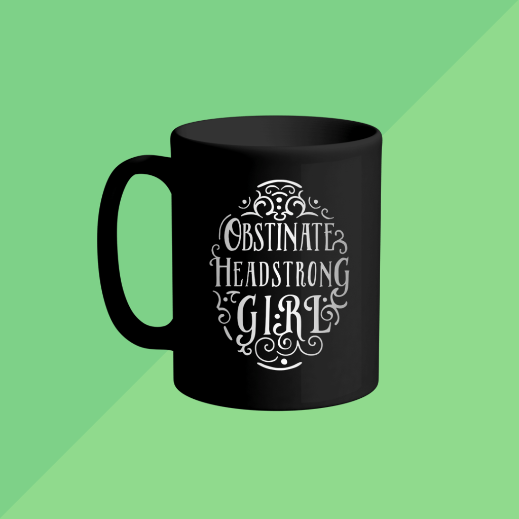 Mug mockup features the "Obstinate, Headstrong Girl" design.