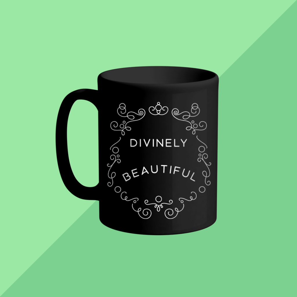 mockup of a black mug with the DIVINELY BEAUTIFUL design from BumbleBess.com