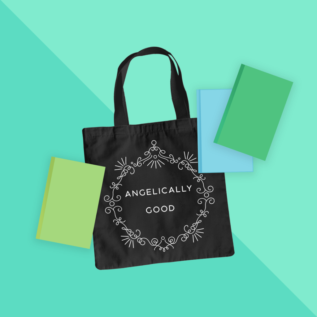 Mockup of a black tote bag with the ANGELICALLY GOOD design from BumbleBess.com