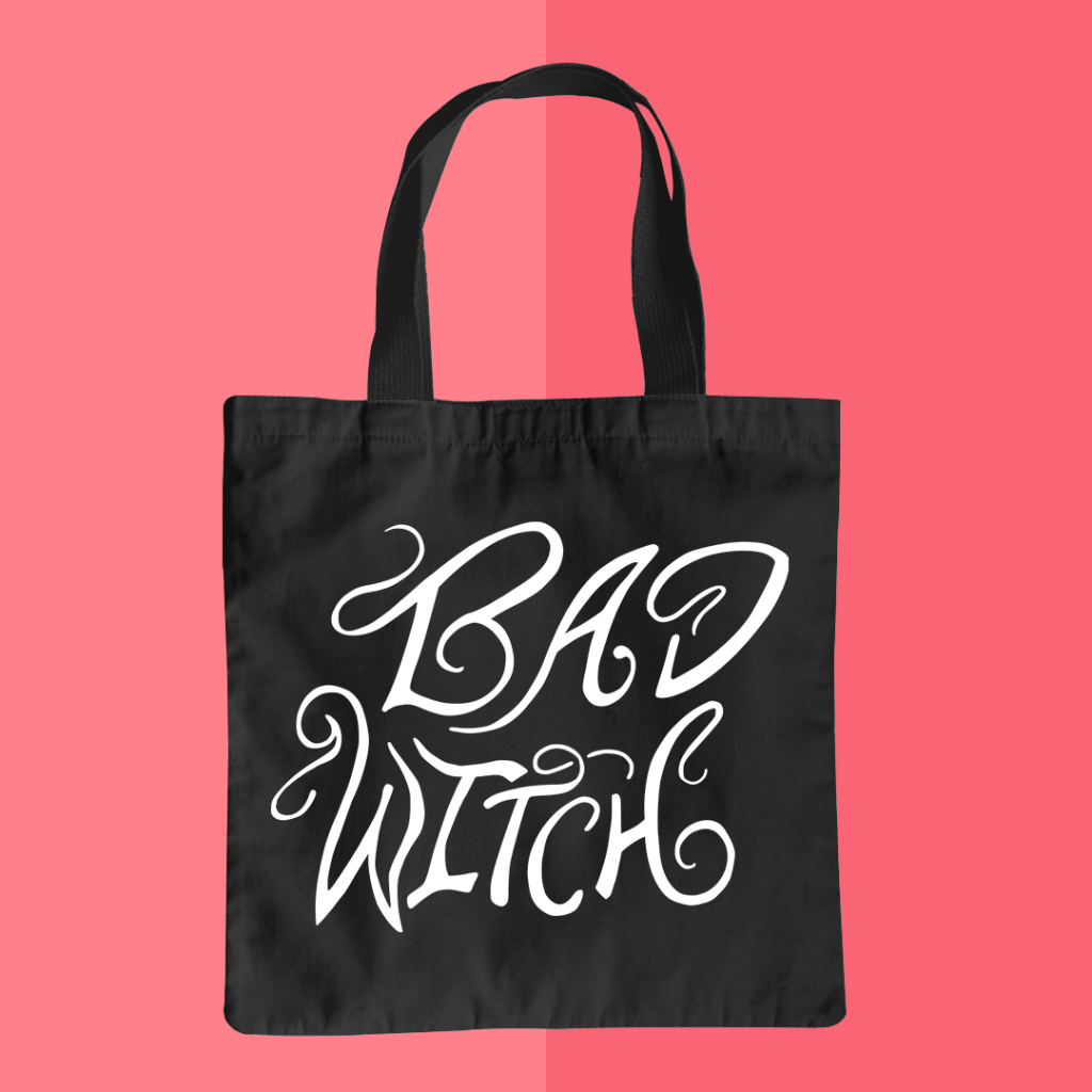 Mockup of a black tote bag featuring the BAD WITCH design from BumbleBess.com