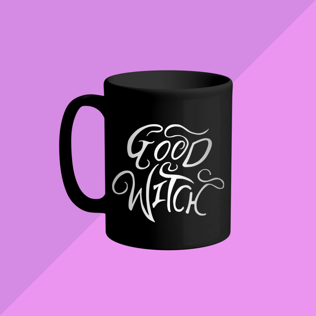 Mockup of a black coffee mug featuring the GOOD WITCH design from BumbleBess.com